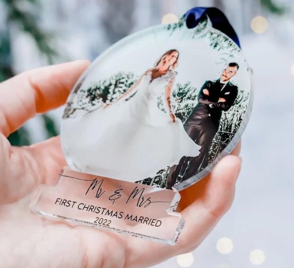 Silver and gold Christmas ornament wedding favors displayed on a holiday tree, a thoughtful keepsake gift for winter wedding guests
