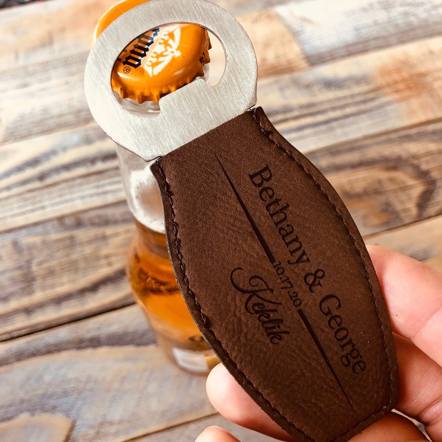 https://www.foreverweddingfavors.com/cdn/shop/products/magnetic-leather-bottle-opener-694757_2000x.jpg?v=1686403347